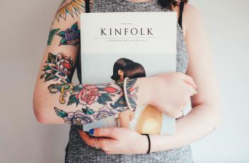 Tattooed girl holding a book