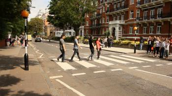 People crossing the street in front of Abbey Road studios, London ...