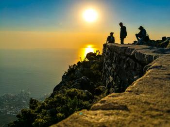 Three Men On Mountain Cliff
