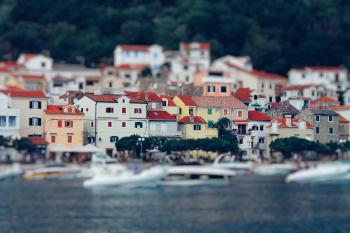 Tilt Shift Lens Photography of Red Roof House Near the Body of Water