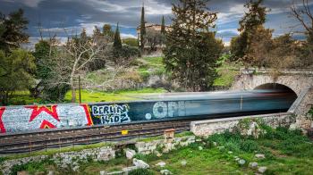 Time Lapse Photography of Train Passing Through Bridge