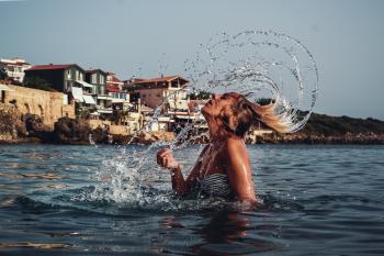 Time-lapse Photography of Woman Playing on Water With Her Hair