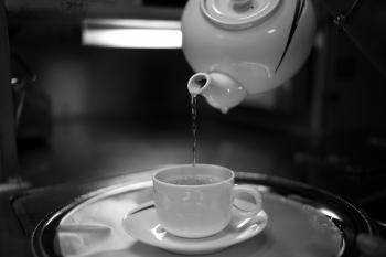 Timelapse Photography of Water Pouring from White Ceramic Teapot to White Ceramic Mug on White Saucer