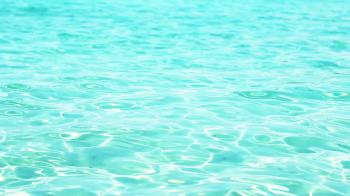 Abstract background of clean turquoise sea with rippled sunlight ...