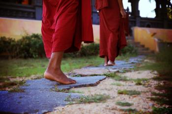 Two Human Wearing Monk Dress Walking on the Pathway