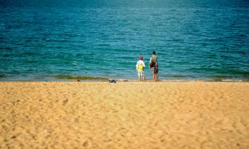 Two Persons Standing Near Beach