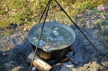 Ukha (fish-soup) cooked with wood ear in a cauldron