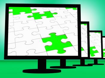 Unfinished Puzzle On Monitors Shows Missing Pieces
