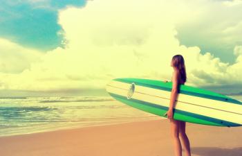 Up to the Challenge - Woman with Surfboard ready to Surf