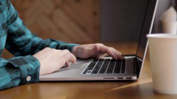 Close-up of male hands using laptop at office, man's hands typing on ...