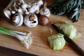Vegetables Mushrooms and Knife on Wooden Board