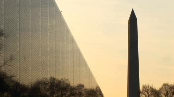 With a golden sky backdrop, the Washington Monument is seen in ...