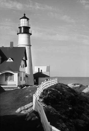 White and Black Lighthouse Near Gray Body of Water