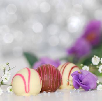 White and Chocolate Sweets With Purple Petal Flower Photo