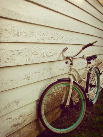White and Teal Beach Cruiser Bike Beside White Painted Wooden Wall