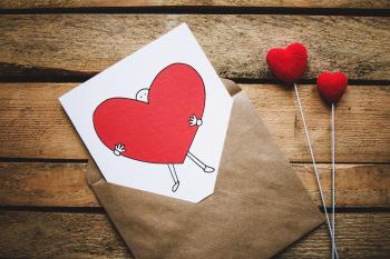 White, Black, and Red Person Carrying Heart Illustration in Brown Envelope