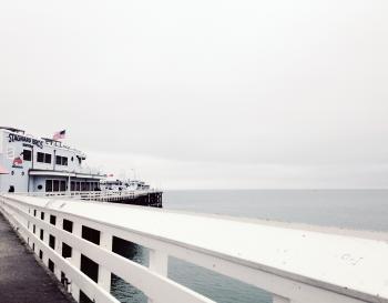 White Cruise Ship Near Concrete Dock on Body of Water Under White Cloudy Sky during Daytime