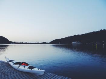 White Kayak on Brown Wooden Dock