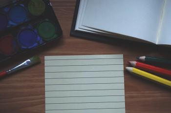 White Ruled Paper Beside Yellow Colored Pencil