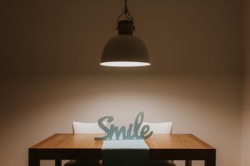 White Smile Cutout Signage on Table