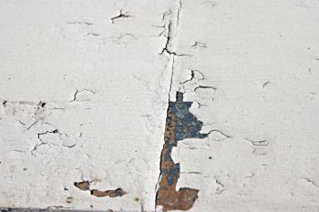 White surface with cracks and pealed pai