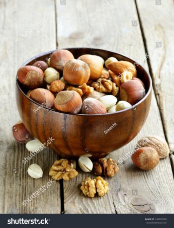 Whole walnuts on rustic old wooden table - With copyspace