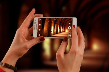 Woman Holding a White Samsung Galaxy Android Smartphone Taking a Photo of Hallway