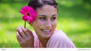 Happy Brunette Woman Holding A Pink Flower Stock video footage | 3880718
