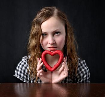 Woman Holding Red Heart Shape Ornament