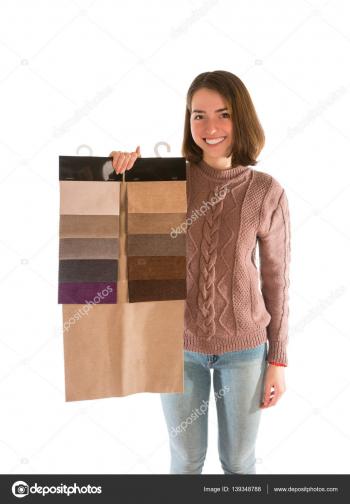 Smiling woman in sweater holding fabric swatches — Stock Photo ...