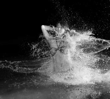 Woman in Bikini in Body of Water in Grayscale Photography