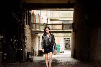 Woman in Black Leather Jacket and Skirt