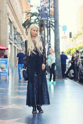 Woman in Black Long Dress Standing on the Pavement