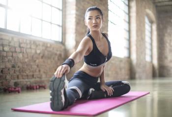 Woman in Black Sports Brassiered and Black Pants Doing Yoga