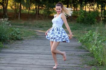 Woman in Blue and White Skated Dress