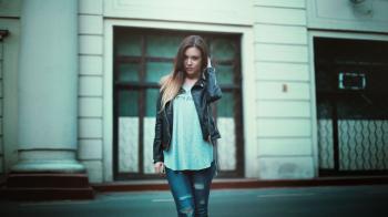 Woman in Gray Printed Shirt With Black Leather Jacket and Black Distressed Jeans