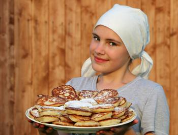 Woman in Grey Crew Neck Shirt Holding a White Ceramic Plate With Pancakes