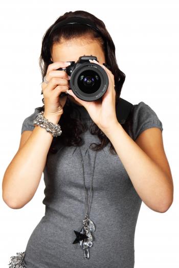 Woman in Grey T-Shirt Using Black DSLR Camera