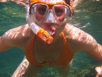 Woman in Orange Bikini Underwater With Snorkel