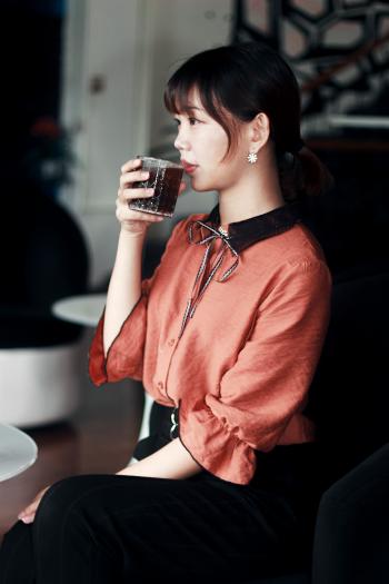 Woman in Pink and Black Dress Drinking Cola