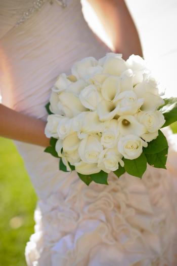Woman in Wedding Dress Holding White Flower Bouquet
