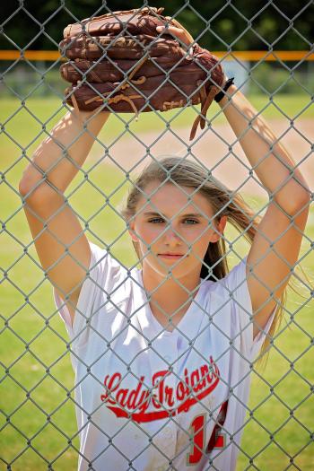 Woman in White Crew Neck T-shirt With Baseball Mitt in Front of Fence