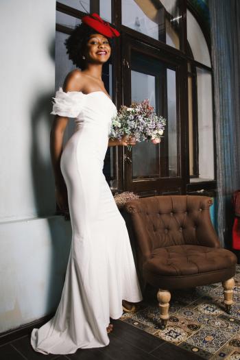 Woman in White Off-shoulder Gown Holding Bouquet of White Flowers