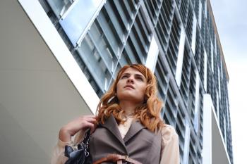 Woman Looking at Modern Office Building