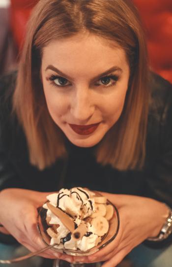 Woman Looking on Camera Holding Bowl With Ice Cream