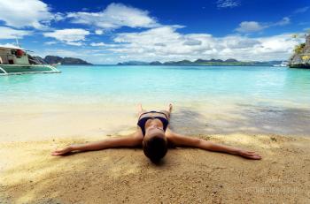 Woman Lying on Sand at Beach