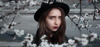 Woman Wearing Black Hat and Dress With Red Lipstick Near White Flowers Selective Focus Photography