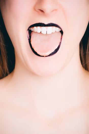 Woman Wearing Black Lipstick Tongue Out Photo
