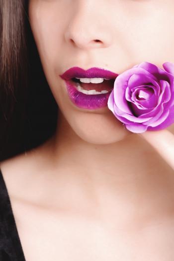 Woman Wearing Black Top Holding Purple Rose Flower