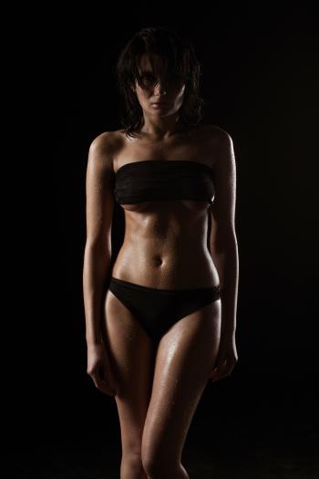 Woman Wearing Black Tube Top and Black Panty in a Dim Lighted Scenario